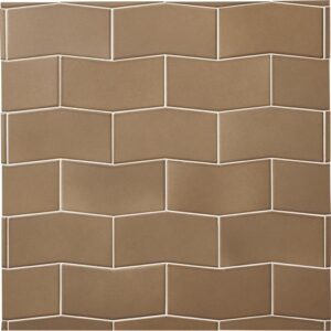 Closeup of light brown wall tile in a geometric arrow shape.