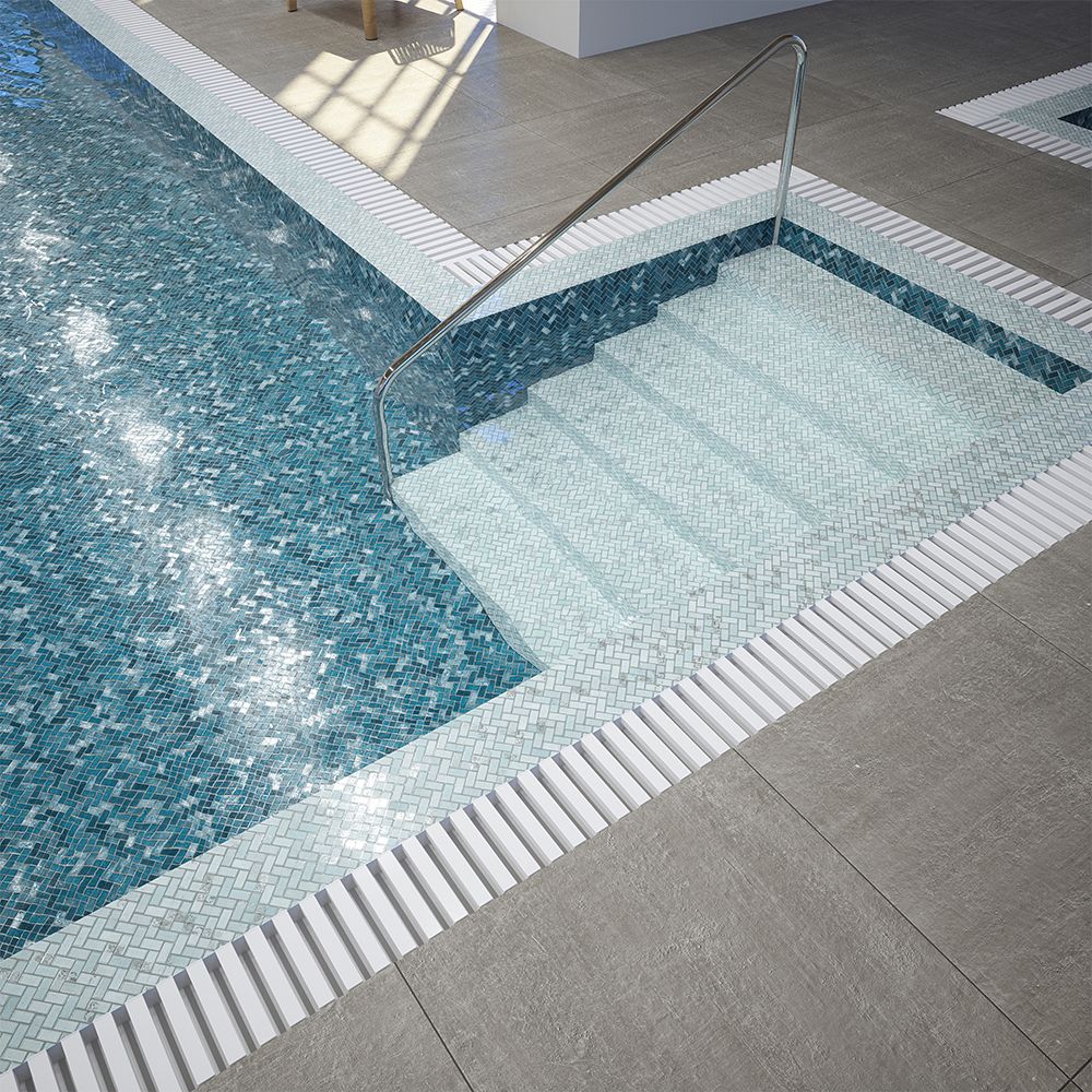 blue and green herringbone glass pool tiles covering pool