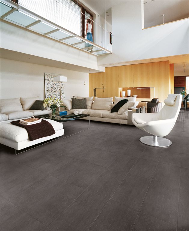 Dark brown floor tiles adding warmth to an open floor plan