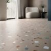 A colorful pattern on beige floor tiles