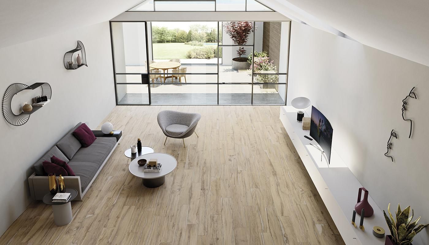 wide shot angle of living room with light colored porcelain floor tile made to look like wood and grey couch