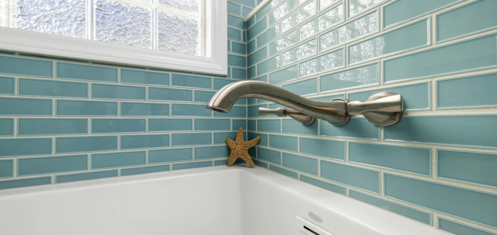 Glossy blue subway tile in a bathtub with a running bond layout