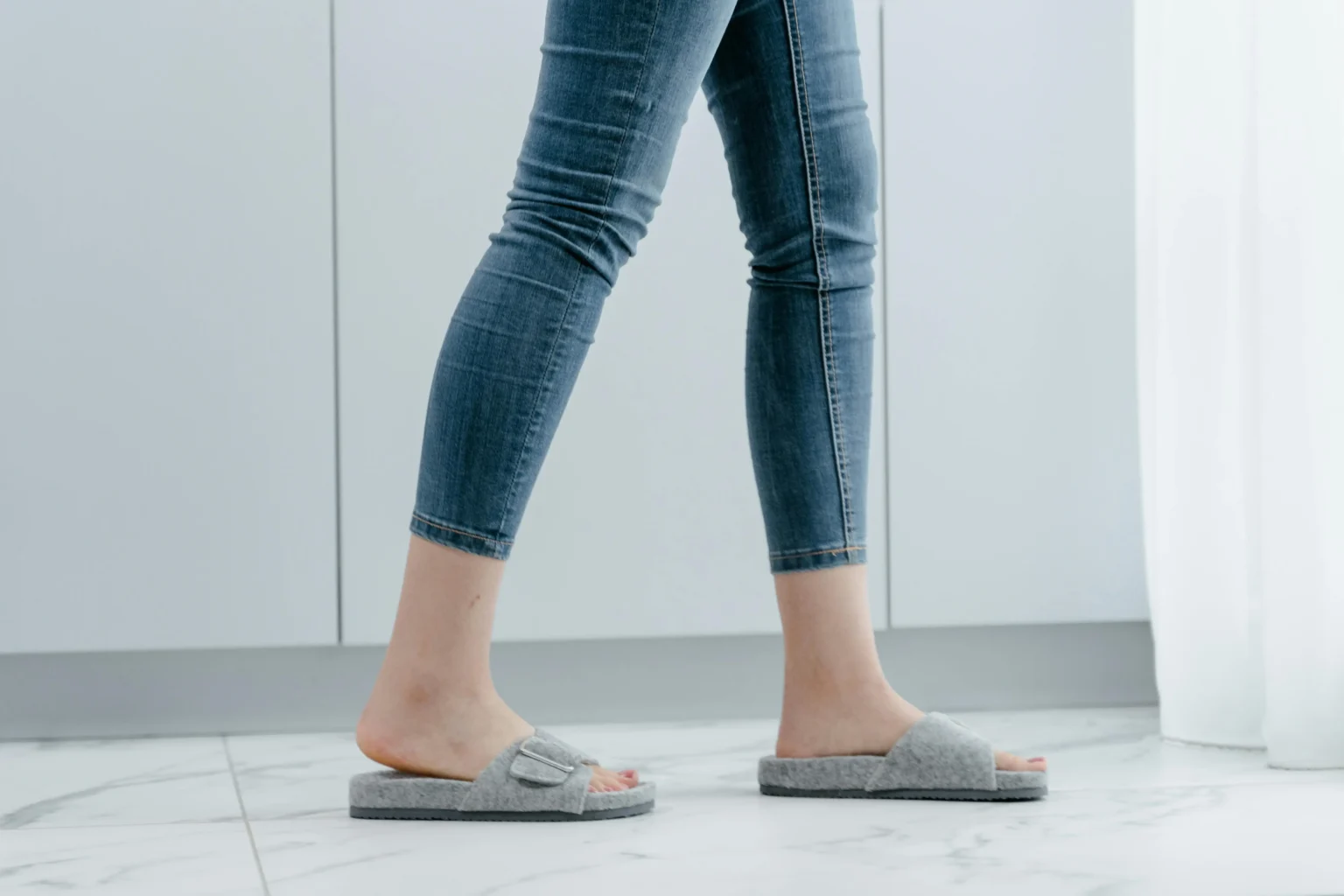 Person walking on a soundproof tile floor with an underlayment