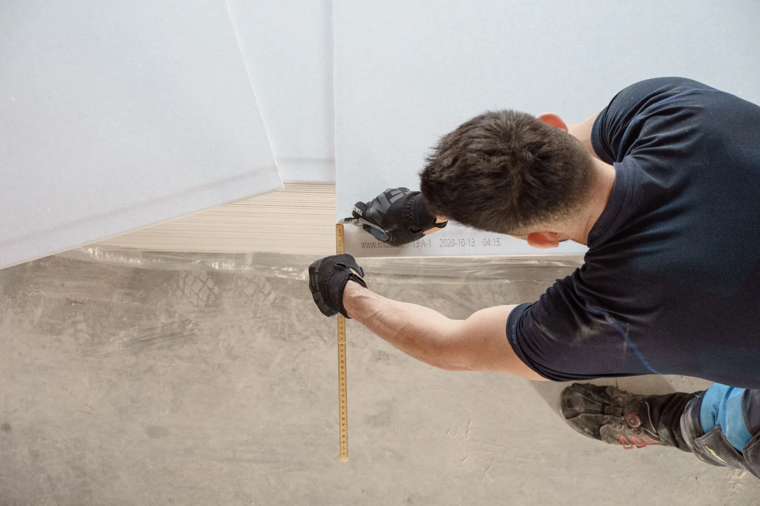 man preparing the subfloor for tile installation