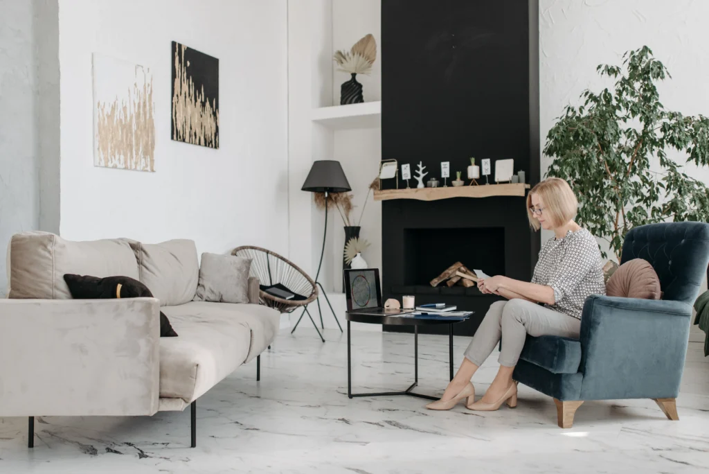 Large format tile flooring in a modern room with a woman sitting on furniture