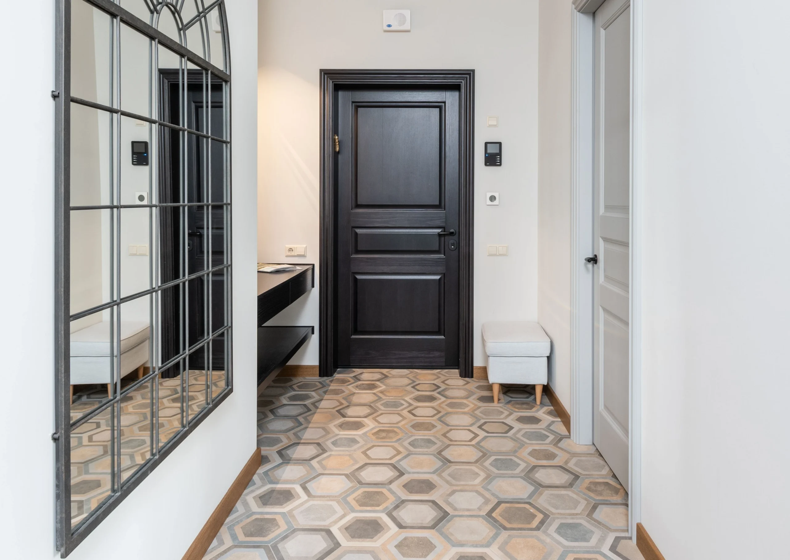 Entryway with tan and gray hexagon patterned tile