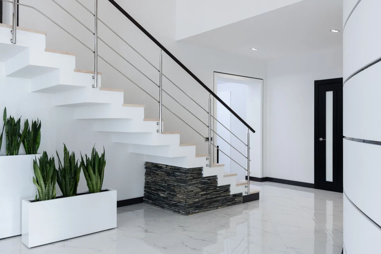 White tile entryway with a staircase