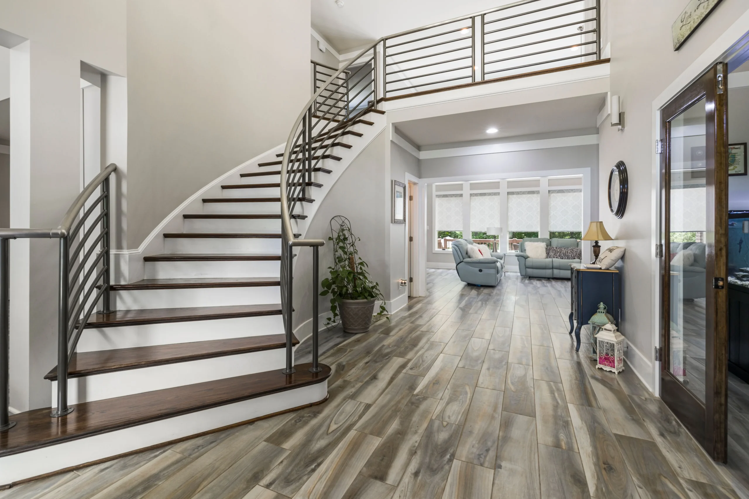 Entryway with wood-look tile leading to a staircase and living area